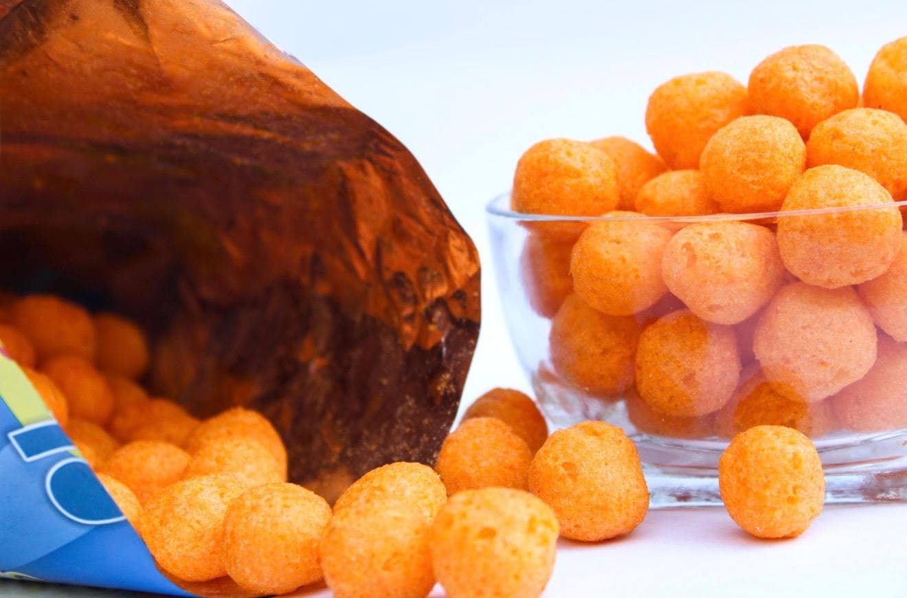 Cheese Pops spilling from bag — crunchy texture